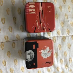 Two fossil watch tins